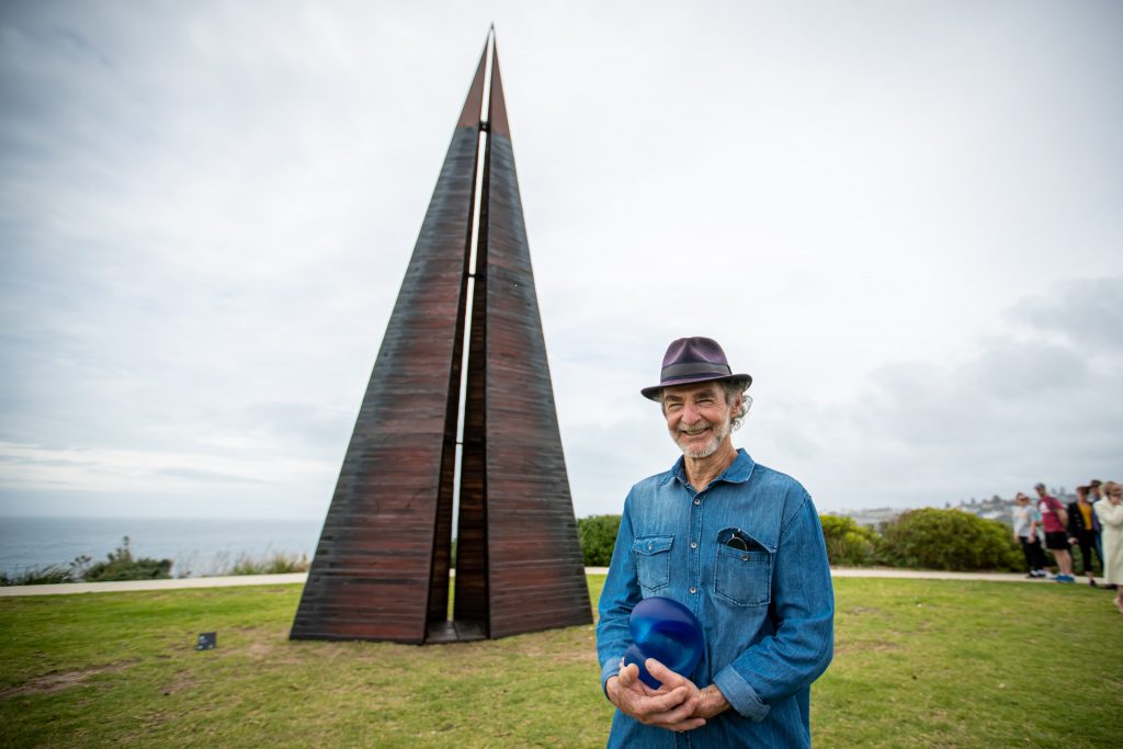 Tony Davis (WA) with his sculpture ‘Folly Interstice’ Sculpture by the Sea, Bondi 2022 Photographer Charlotte Curd